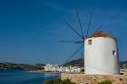 A scenic view of the Parikia waterfront and a traditional windmill Cyclades Islands-Greece Art Print